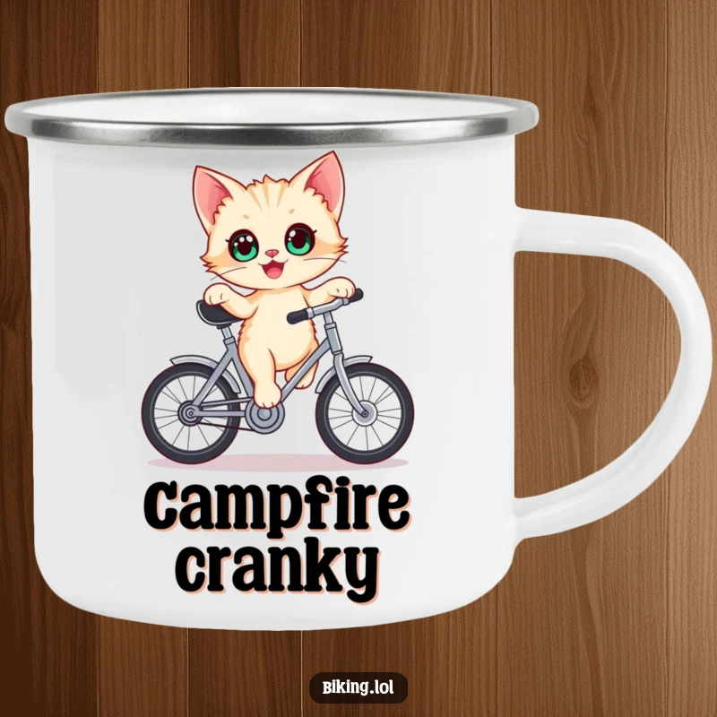 Funny kitten camping mug, delighted kitten with wide eyes balancing on a stationary bicycle crank outdoors.