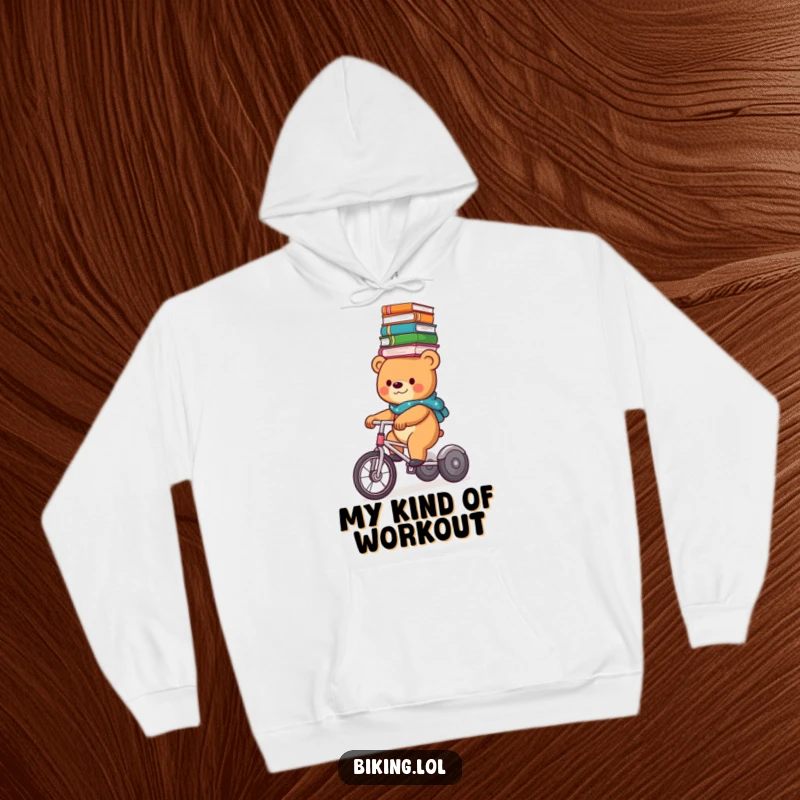 A funny bear confidently rides a tricycle, a stack of books perfectly balanced on its head, featured on a soft hoodie.