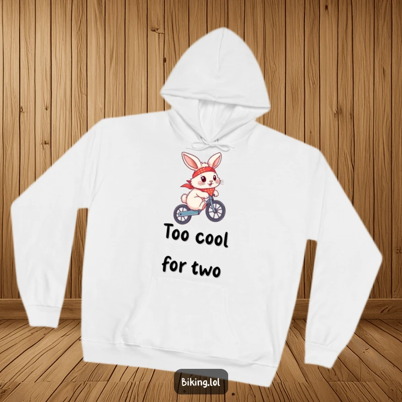 Funny bunny with a bandana flying, doing a wheelie on a bike, on a cozy hoodie, embodying cool.