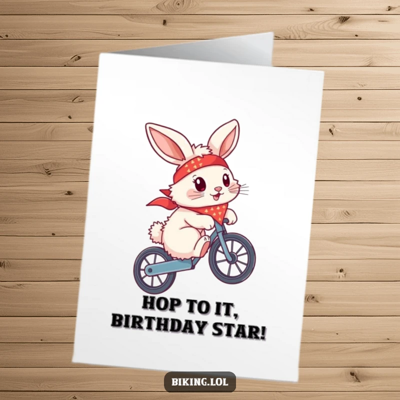 Funny free printable birthday card, a fluffy bunny with a bandana flying, attempting a wheelie on a bike, looking cool.