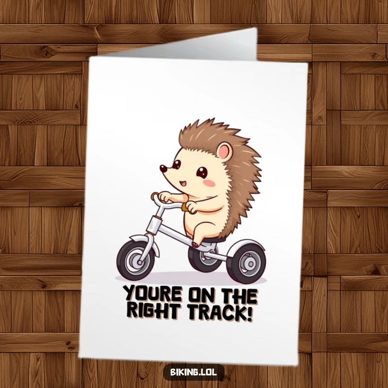 Funny Free Printable Congratulations Card: Excited hedgehog on a tricycle, pointing ahead, celebrating new achievements, perfect downloadable gift.