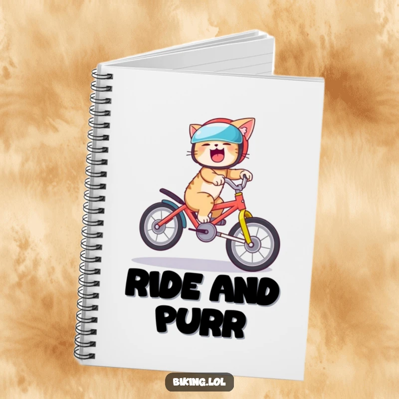 Funny cat notebook with a giggling cat in a helmet riding a bike and doing a wheelie, perfect for humorous note-taking.