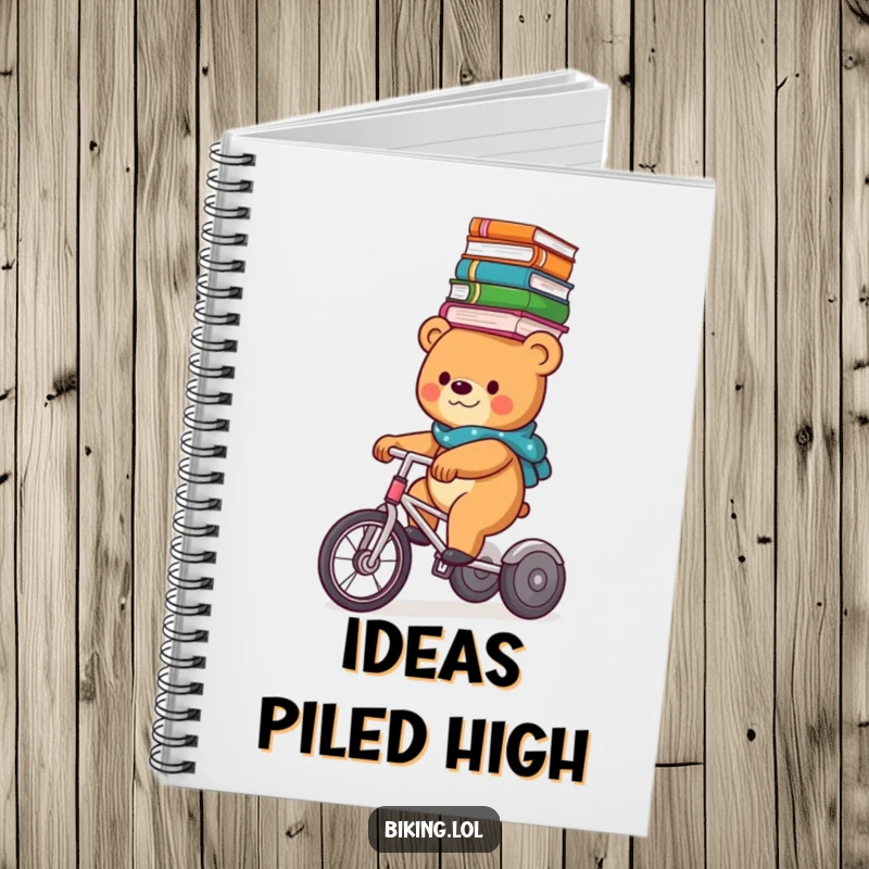 Funny bear balancing books on its head while riding a tricycle, featured on the cover of a humorous notebook.