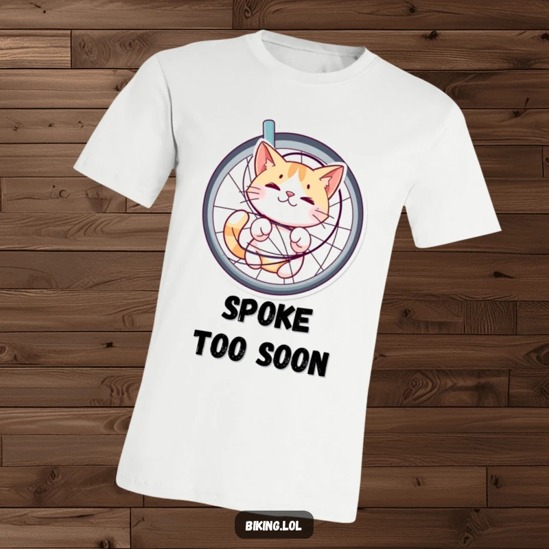 Funny t-shirt showcasing a cat happily bewildered while tangled in bicycle spokes, a whimsical and amusing design for cat enthusiasts.