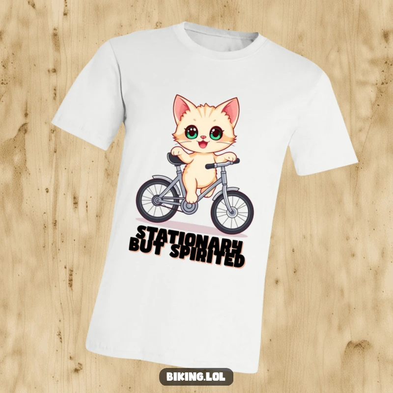 Funny kitten t-shirt, depicted with wide eyes, delighted, balancing on a stationary bicycle crank with intense focus.