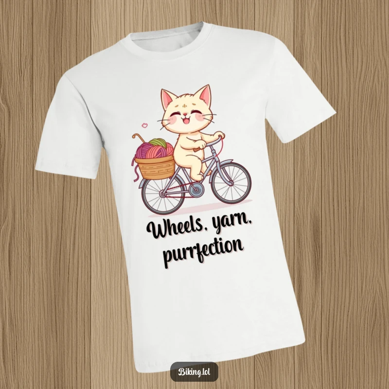 Funny t-shirt graphic of a giggling cat enthusiastically riding a bicycle, its basket brimming with a chaotic yet delightful amount of yarn.