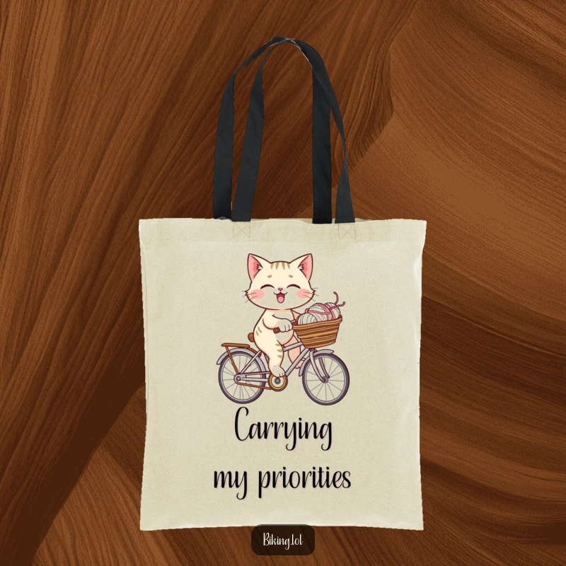 Funny giggling cat riding a bicycle laden with yarn, depicted on this stylish and humorous tote bag.