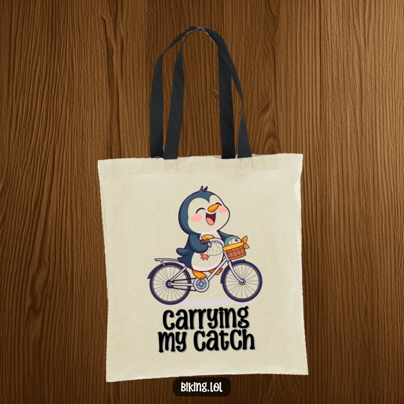 Funny penguin tote bag showing a laughing bird riding a bicycle with a fish in its basket, a humorous carry-all.